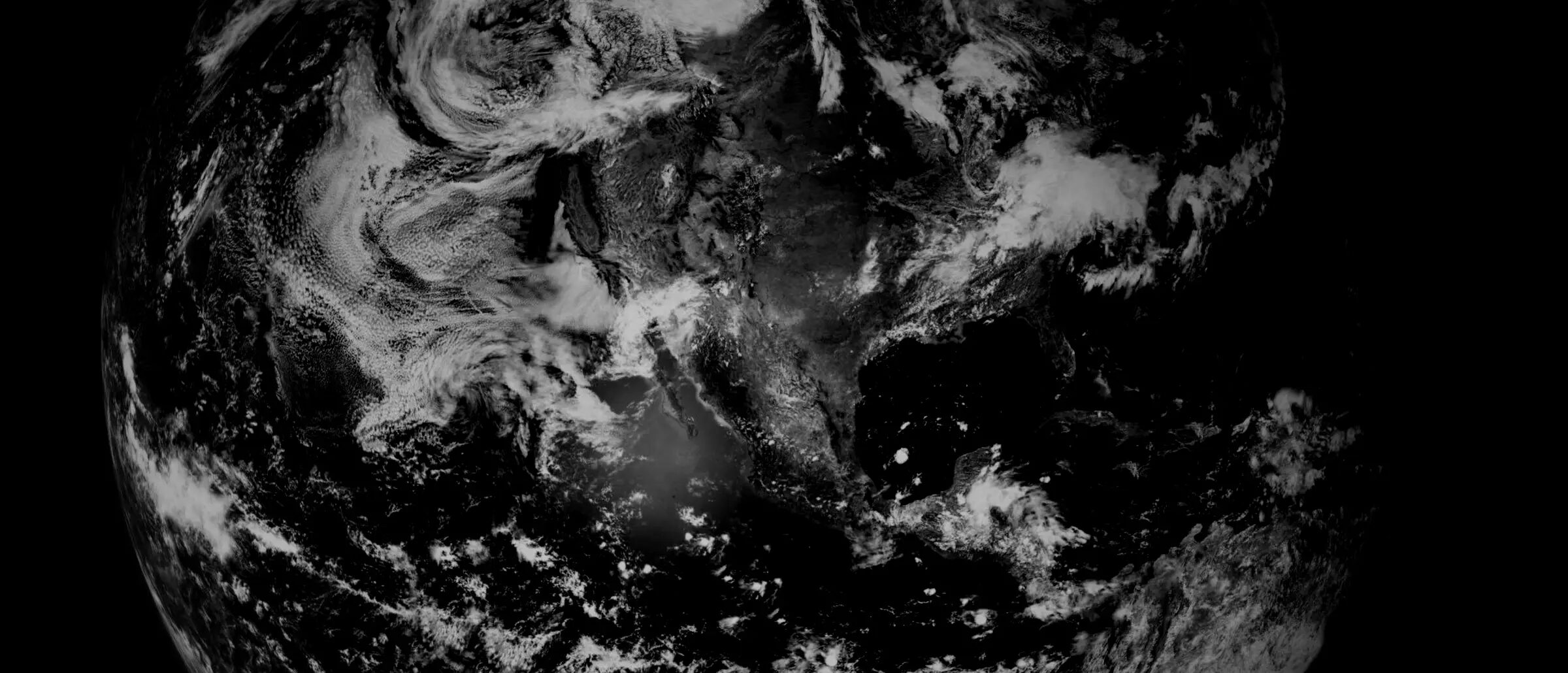 Earth from orbit, cloud patterns over land and ocean.